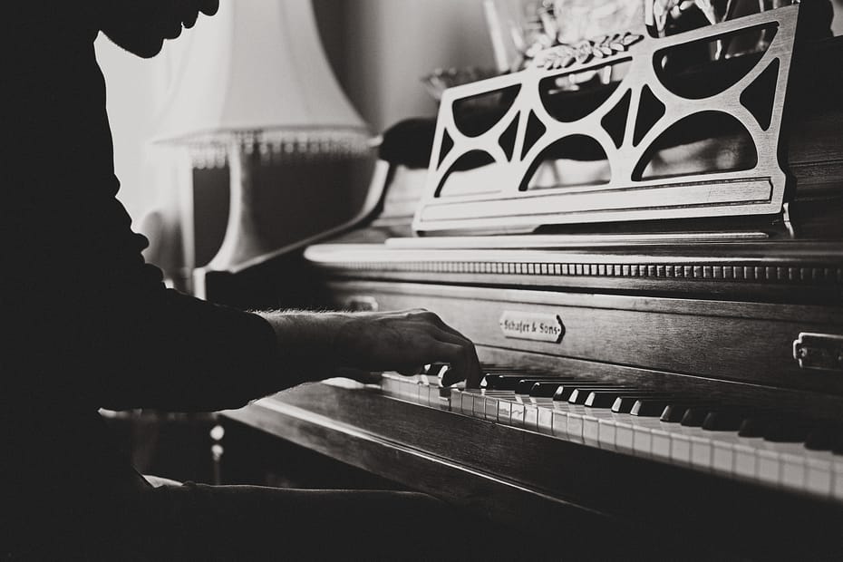 Capturing the essence of self-discovery and growth: A person playing the piano, illustrating the transformative journey discussed in the blog post